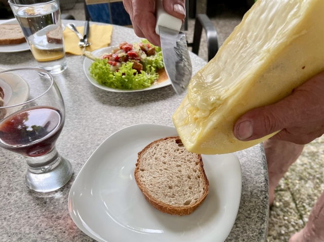 Der geschmolzene Käse wird abgestrichen